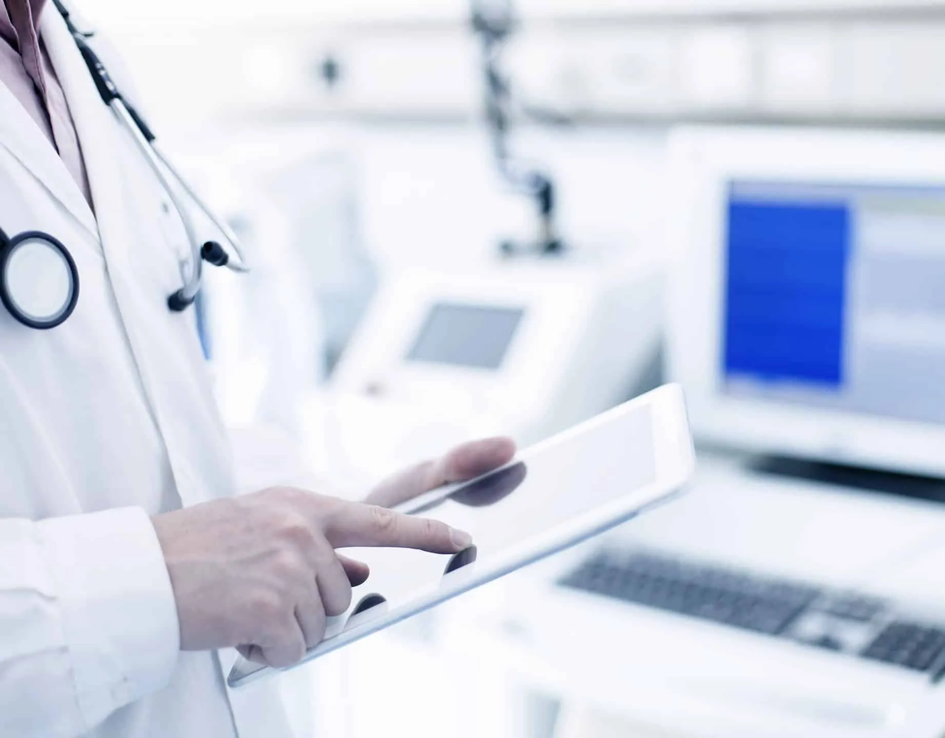 A doctor checking notes on a tablet
